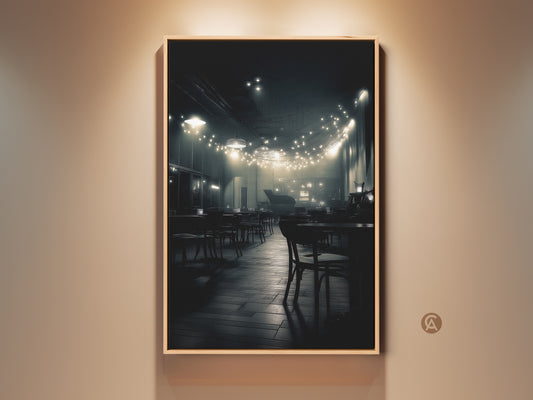 A captivating black and white photograph shows a dimly lit cafe. Strings of lights hang above empty tables creating a warm inviting glow. The artwork captures a quiet intimate atmosphere. This creates a timeless piece for your home decor.