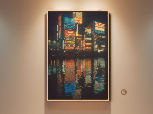 A framed canvas print displays urban Japanese neon artwork. This cityscape nightlife wall decor features blue yellow and orange colors. See the vibrant reflections on the water. A contemporary travel gift idea.