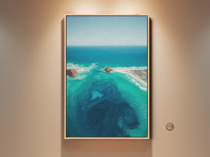 Framed aerial ocean abstract canvas print. This turquoise coastal landscape wall art features deep blue swirls. The beach house decor is a perfect gift for the home. This wall art adds a modern touch.