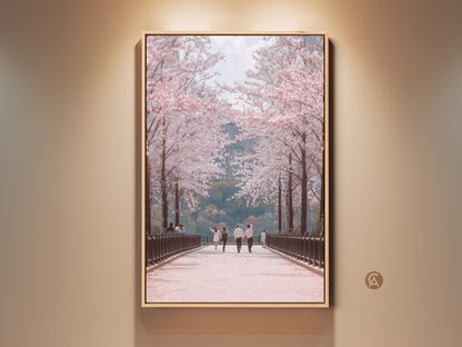 Experience the romance of spring with this art print. A couple strolls along a cherry blossom path. This pastel pink and green landscape offers contemporary botanical beauty. Perfect bedroom wall decor or an anniversary gift. It brings a touch of spring's renewal to any room.