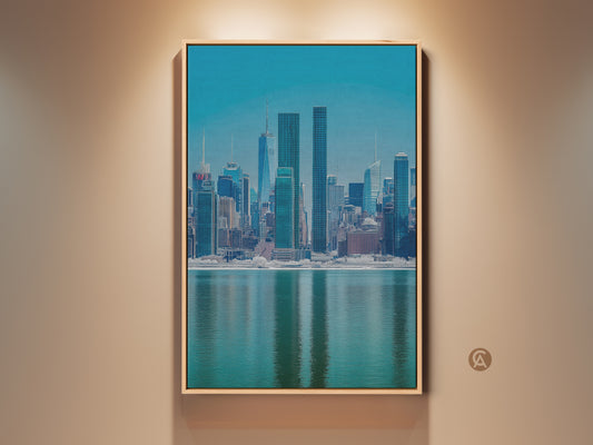 Modern NYC Skyline canvas art in a wood frame. This blue teal cityscape print offers a waterfront urban architecture view. Perfect wall decor for your office or living room. The contemporary artwork adds a touch of sophistication to any space.
