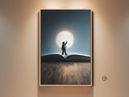 Surreal child dream art print framed in a light wood floating frame. This fantasy wall art features a child reaching for the moon atop an open book. Conceptual nursery decor is rendered in blue yellow and teal tones.