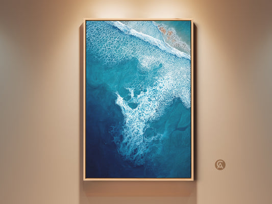 Framed deep blue ocean wave canvas art brings coastal tranquility. The turquoise aerial view artwork in a natural wood frame enhances bedroom wall decor. It's a perfect beach gift for ocean lovers. This abstract coastal print captures the sea's beauty. Ready to hang abstract seascape painting for your home.