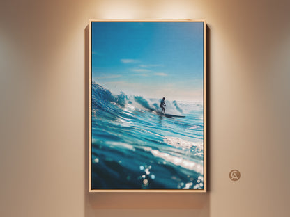 A framed canvas print showcases a surfer riding a majestic blue wave. The artwork captures the power and beauty of the ocean. Perfect wall art for surf enthusiasts. The oak floating frame enhances this ocean scene. Ready to hang and enjoy.