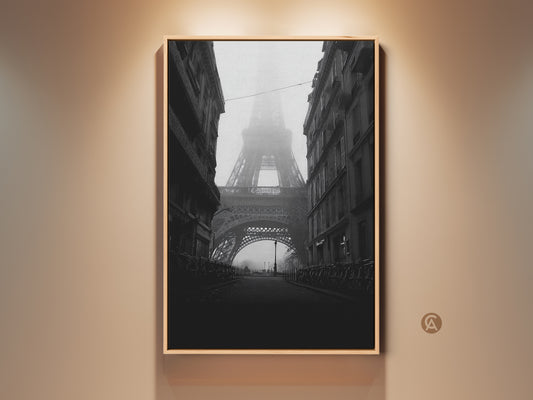 Monochrome Eiffel Tower art displayed in a gold frame. This Parisian street scene is captured in black and white with subtle grey tones. It provides a vintage travel aesthetic. The artwork enhances bedroom living room or home office decor with its contemporary yet classic appeal.