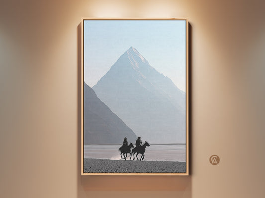 Minimalist Western art print of cowboys on horseback. Misty blue mountain canvas creates a serene scene. Perfect home and living room wall decor. Ideal for rustic and modern spaces adding a touch of adventure. Equestrian artwork evokes a peaceful mountain scene.
