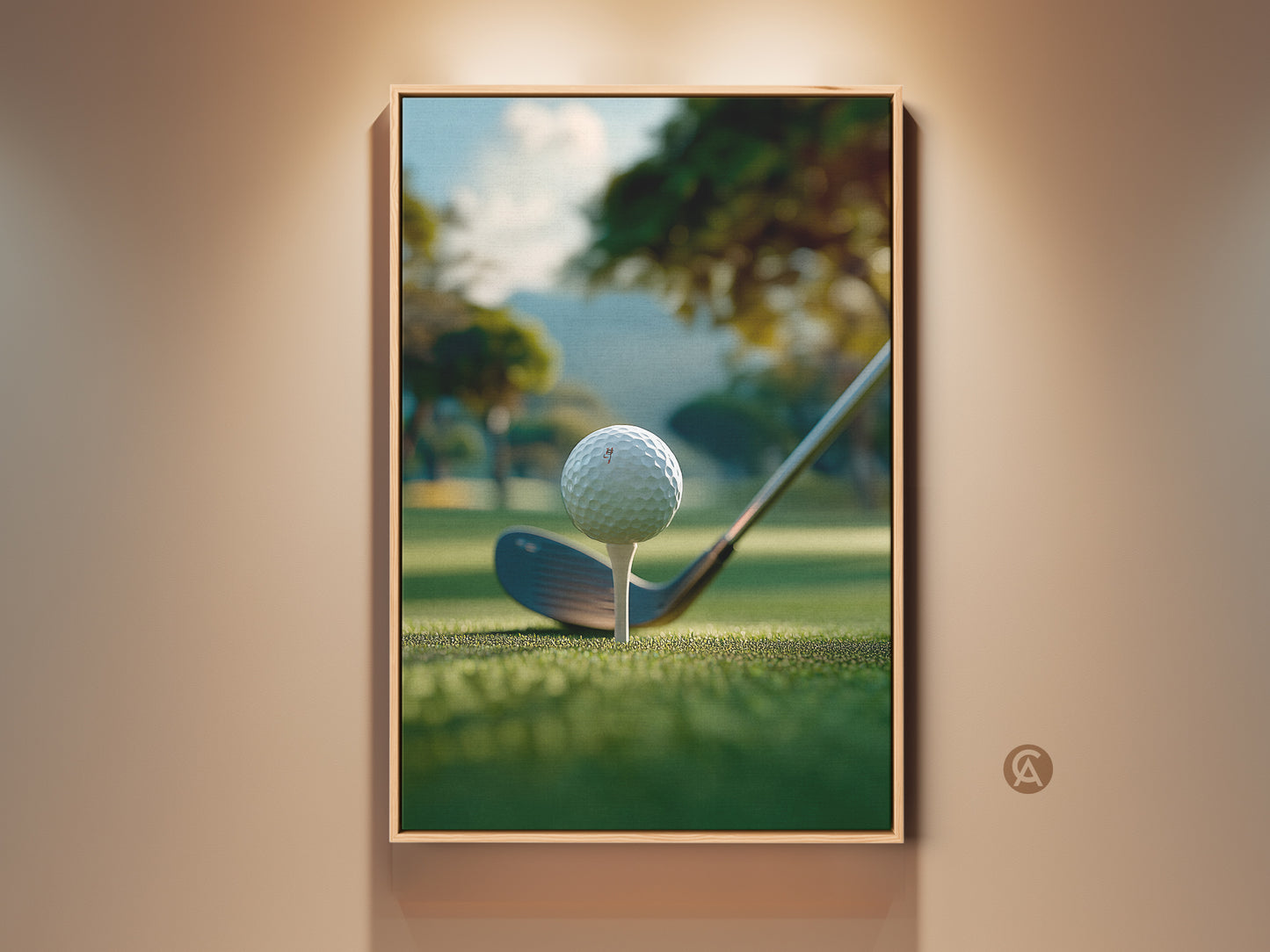 A framed golf art print hangs on a beige wall. The artwork shows a golf ball on a tee ready to be hit. The background is a green golf course with trees and a hill. This framed golf art print is perfect for your home or office.