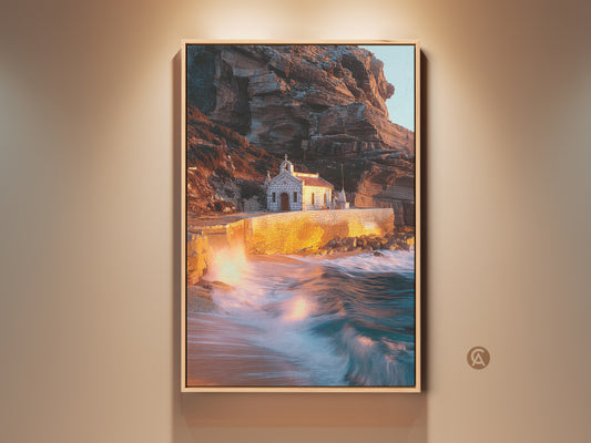 Framed coastal chapel art print showcases warm earth tones and teal accents. This Mediterranean coastal art captures dramatic ocean waves against rugged cliffs. The housewarming gift brings seaside charm to any living room or entry hall with this captivating landscape photography.