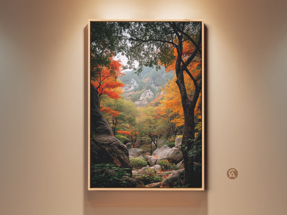 Framed landscape art featuring a vibrant autumn forest scene. The artwork showcases colorful trees and rocky terrain. The frame accentuates the natural beauty of the landscape. This wall art brings nature's splendor indoors. Perfect for adding a touch of fall to any room.