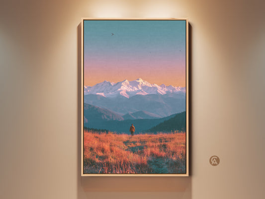 Framed landscape art showcasing a solitary figure on a golden field. Snow-capped mountains rise in the background. A serene sky blends orange and blue hues. Perfect wall decor for nature lovers. Buy canvas prints online.