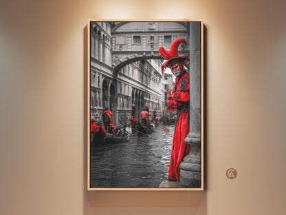 This canvas print showcases Venetian Carnival Wall artwork. A person in a red masquerade costume stands by a canal. Gondolas float by in black and white creating an eclectic travel decor piece. This theatrical art gift is truly unique.