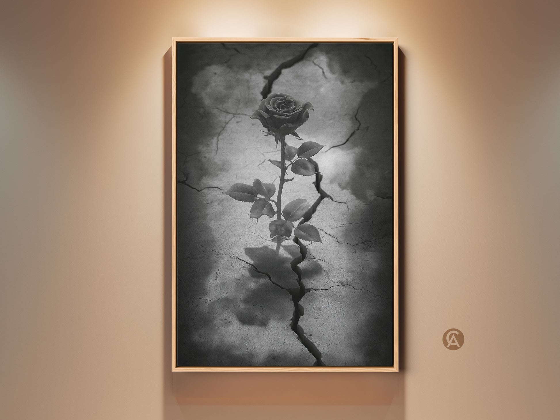 Framed gothic rose artwork displayed against a neutral wall. This dark floral artwork features a rose emerging from cracked earth. It's a surreal botanical canvas in black white and gray tones. This art piece adds an eclectic touch to home residential art. Perfect as a gothic bedroom art or anniversary gift.