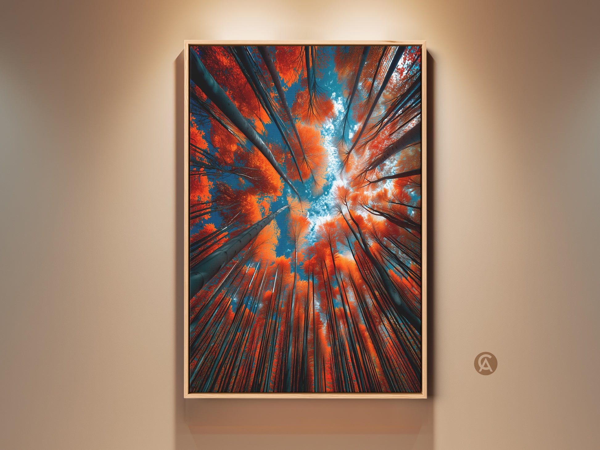Framed artwork of a forest canopy. Looking up at the trees. The leaves are a vibrant orange color. The sky is visible through the branches. This art is a great addition to any home.