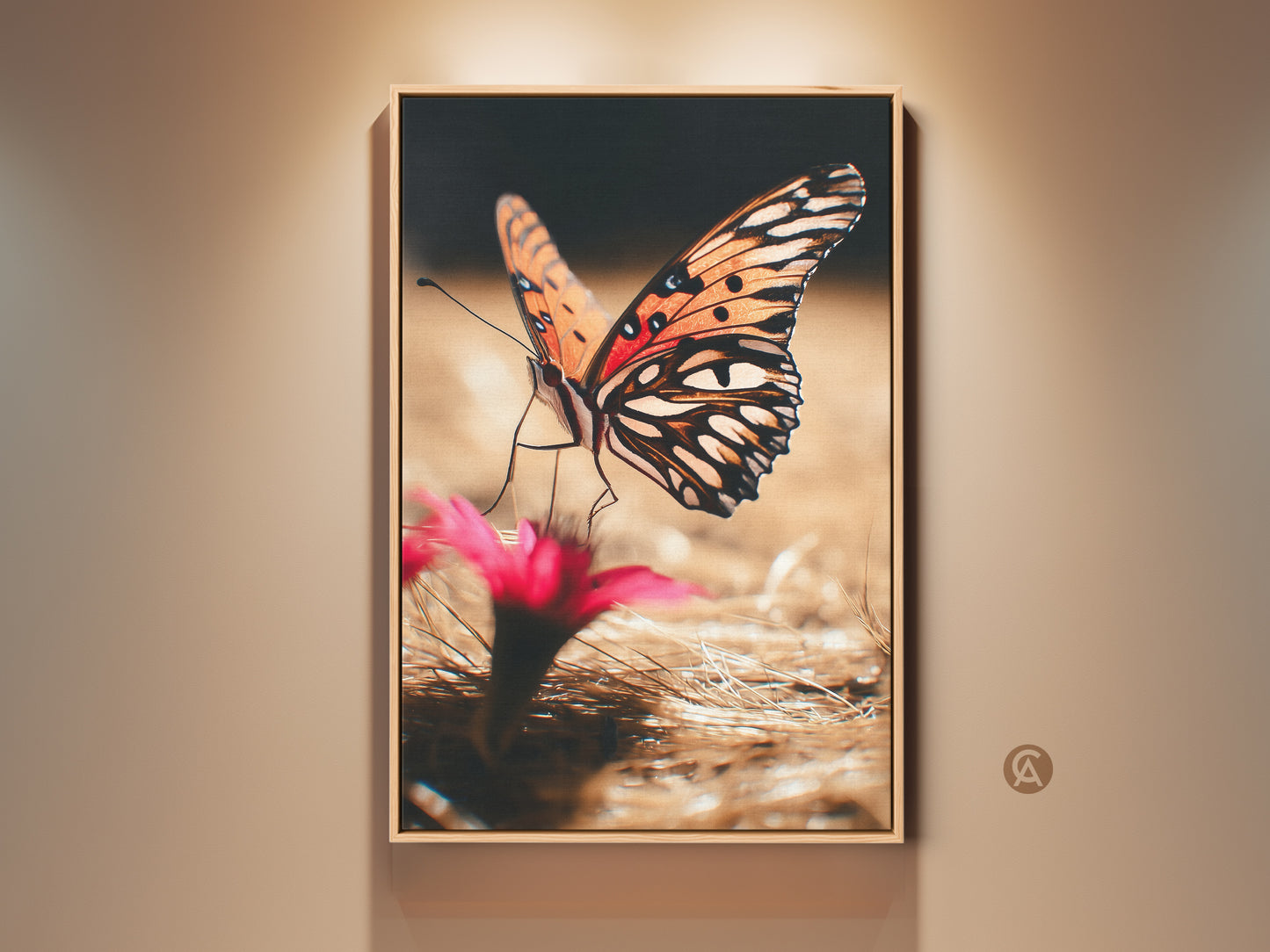 Framed orange butterfly art on a wall. This nature photography print features a realistic insect close up. The boho canvas print adds vibrant color to bedroom decor. A perfect gift for nature lovers. The artwork captures the intricate details of the butterfly's wings with floral accents.