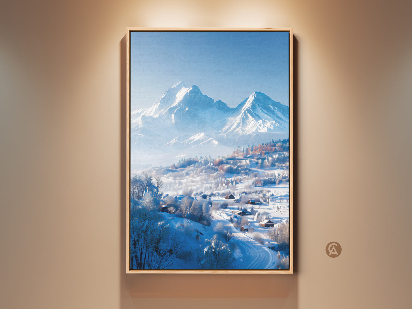 Framed winter mountain art hangs on a beige wall. The artwork captures snow covered mountains and houses. The floating frame adds depth. This framed canvas is ready to hang. Perfect wall art to elevate your space