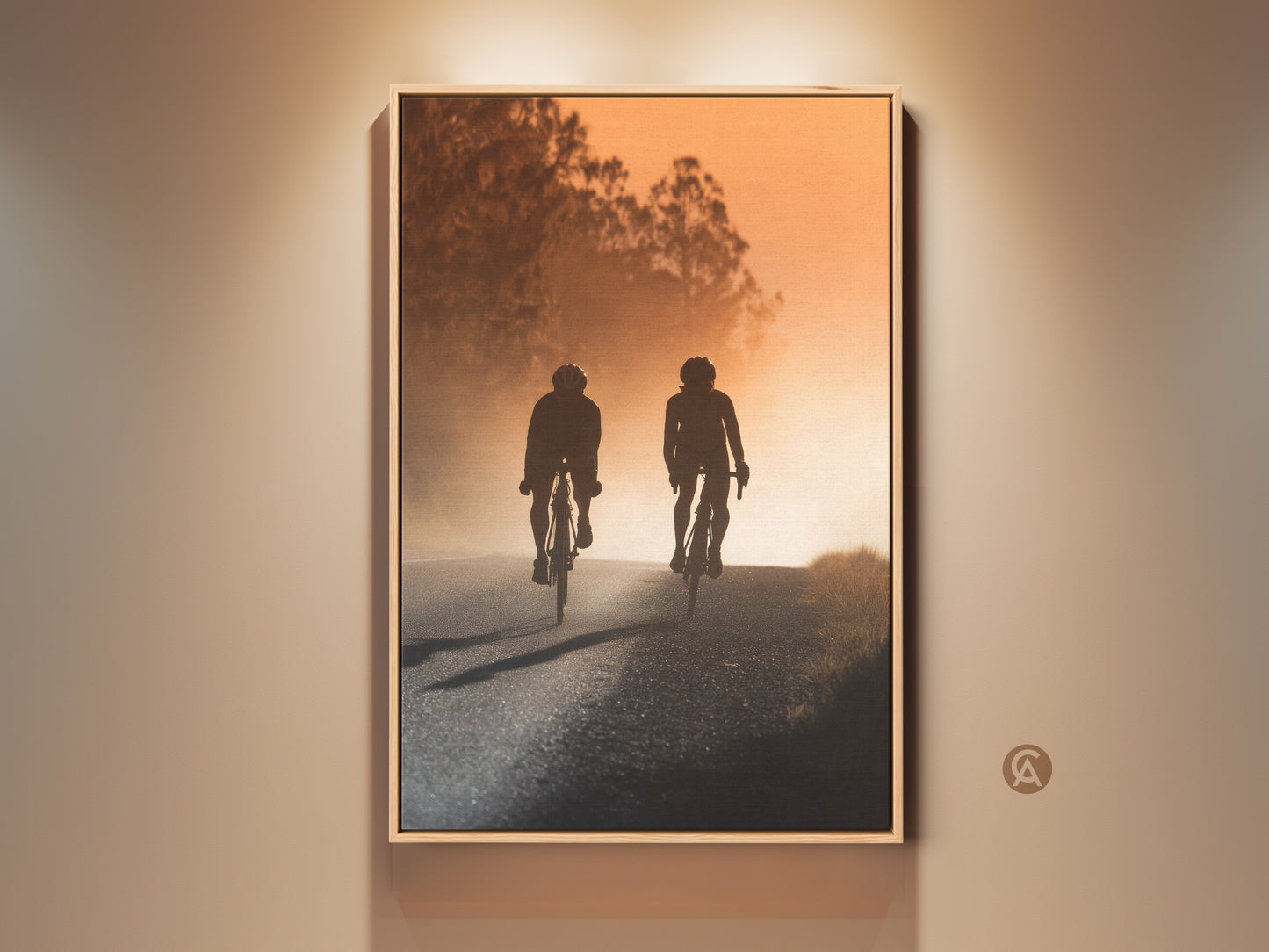 Modern cycling couple art print in warm amber tones. A silhouette of cyclists on a road journey. Perfect entryway home decor or gift for cyclists. This modern landscape canvas adds an adventurous touch to any room. A sophisticated visual for lovers of cycling and travel.
