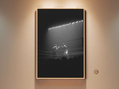 Dramatic black and white boxing match artwork hangs in a spotlight lit room. This sports photography print brings industrial style to man caves and offices. A unique gift for fighter fans.
