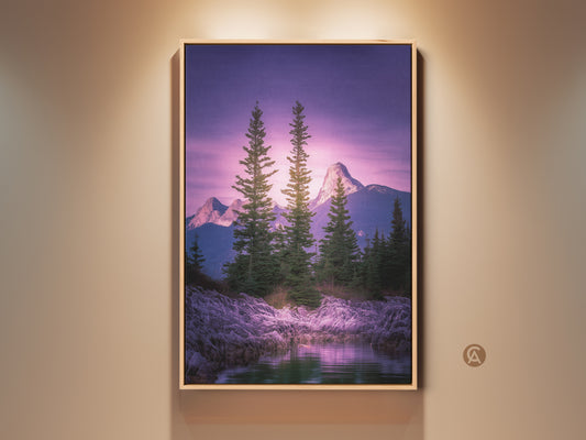 Framed pine tree mountain art print. Violet and green landscape canvas in a wood frame. Rocky shoreline wall decor for a bedroom. Nature artwork brings a serene mountain view indoors.