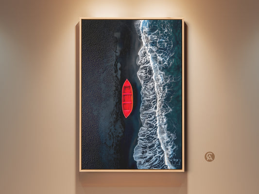 Framed aerial beach artwork featuring a red boat near the shore. The artwork is displayed in a natural wood floating frame. The wall art enhances any room's aesthetic appeal. Buy this striking piece today.
