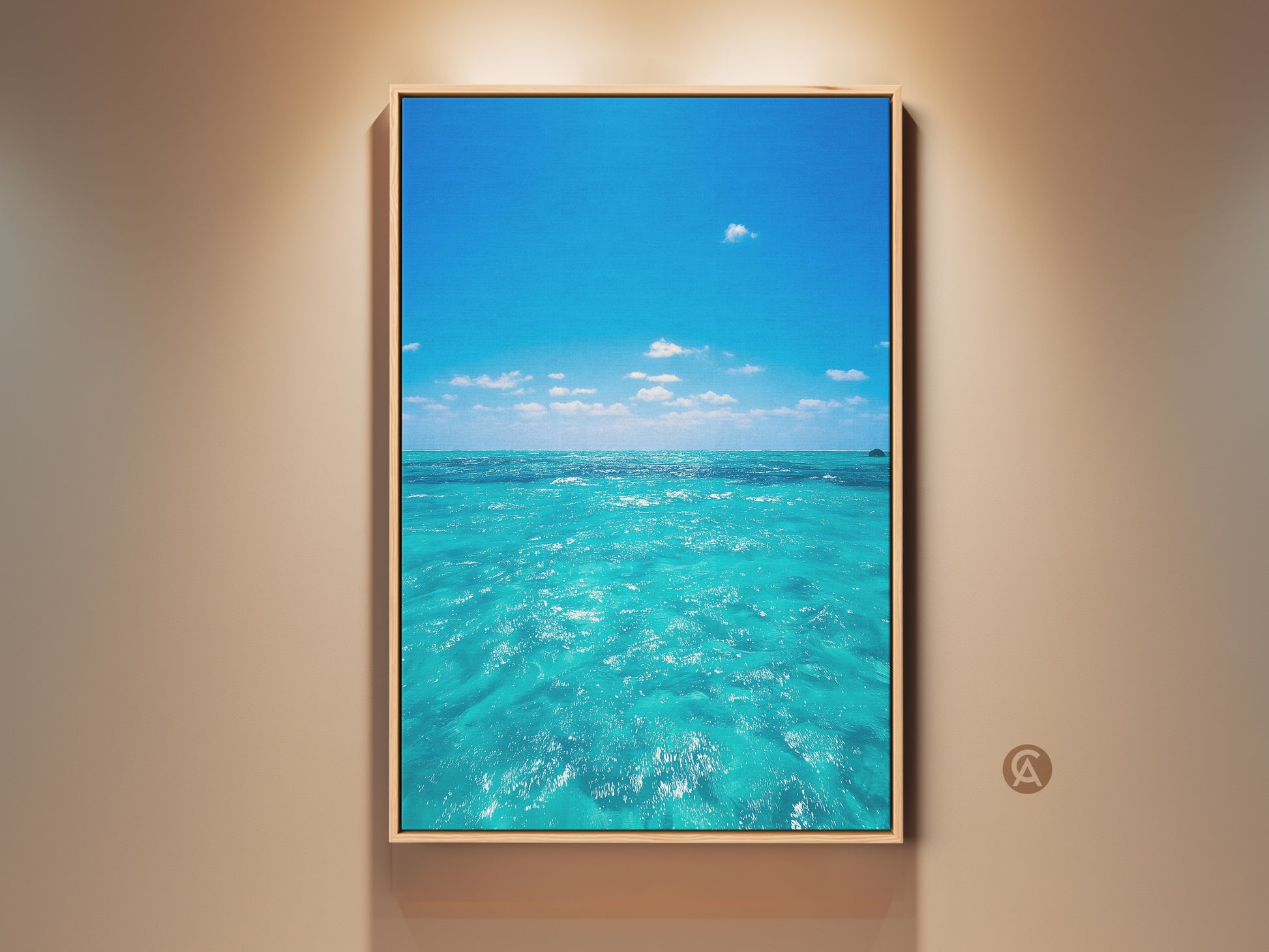 Turquoise ocean art print displayed in a room. The artwork captures a coastal scene with a blue sky and clear water. Perfect beach house decor. This summer gift brings a tropical paradise indoors. The ocean view canvas art adds a nautical touch to any space.