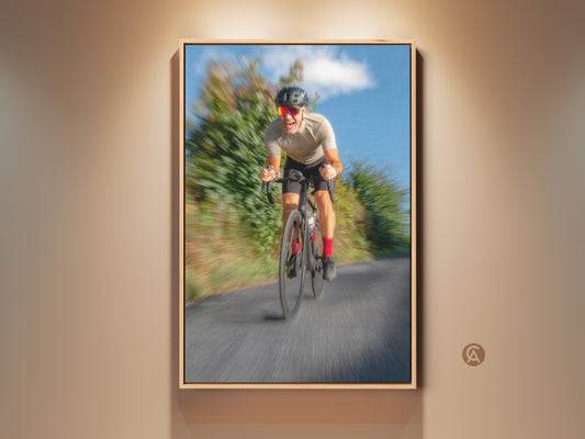 Framed contemporary cyclist canvas print. This motion blur road action art adds energy to any space. Blue grey wall decor is perfect for office and gym settings. A unique gift for cyclists who appreciate action photography wall art.