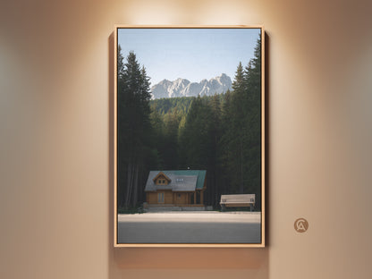 Mountain Cabin Canvas Print for rustic nature decor. The forest landscape wall art brings outdoor charm to any room. A serene log cabin is nestled in a forest with mountains. It is a great housewarming present.