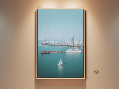 Ocean Cityscape Aerial Art Print in a wood frame. Features a sailboat cruise ship wall decor in a blue teal modern photography style. Perfect travel lover gift and wall art.
