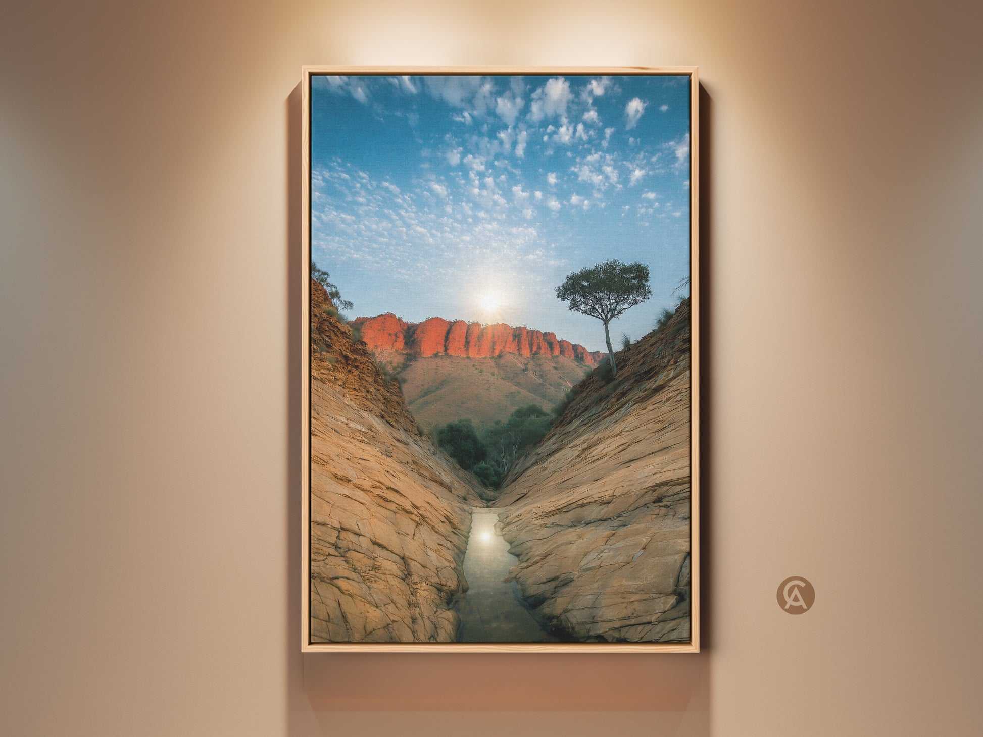 Experience the beauty of Australian desert canyon wall art. This canvas print showcases a red rock landscape bathed in sunlight. A perfect piece for entry hall decor or a unique travel themed gift. This nature photography brings the outback to your home with orange and blue tones.