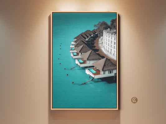 Framed minimalist overwater bungalows art print. The turquoise ocean landscape brings a touch of contemporary resort wall decor to your home. This travel gift is perfect for adding a serene blue and brown wall art to your living room.