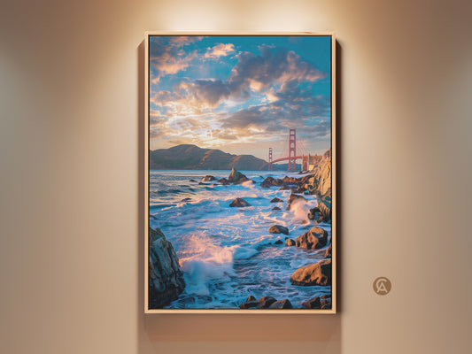 Framed Golden Gate Bridge art print on a beige wall. This photorealistic canvas captures teal and orange sunset over ocean waves. Ideal coastal artwork for modern home decor or a traveler's gift.