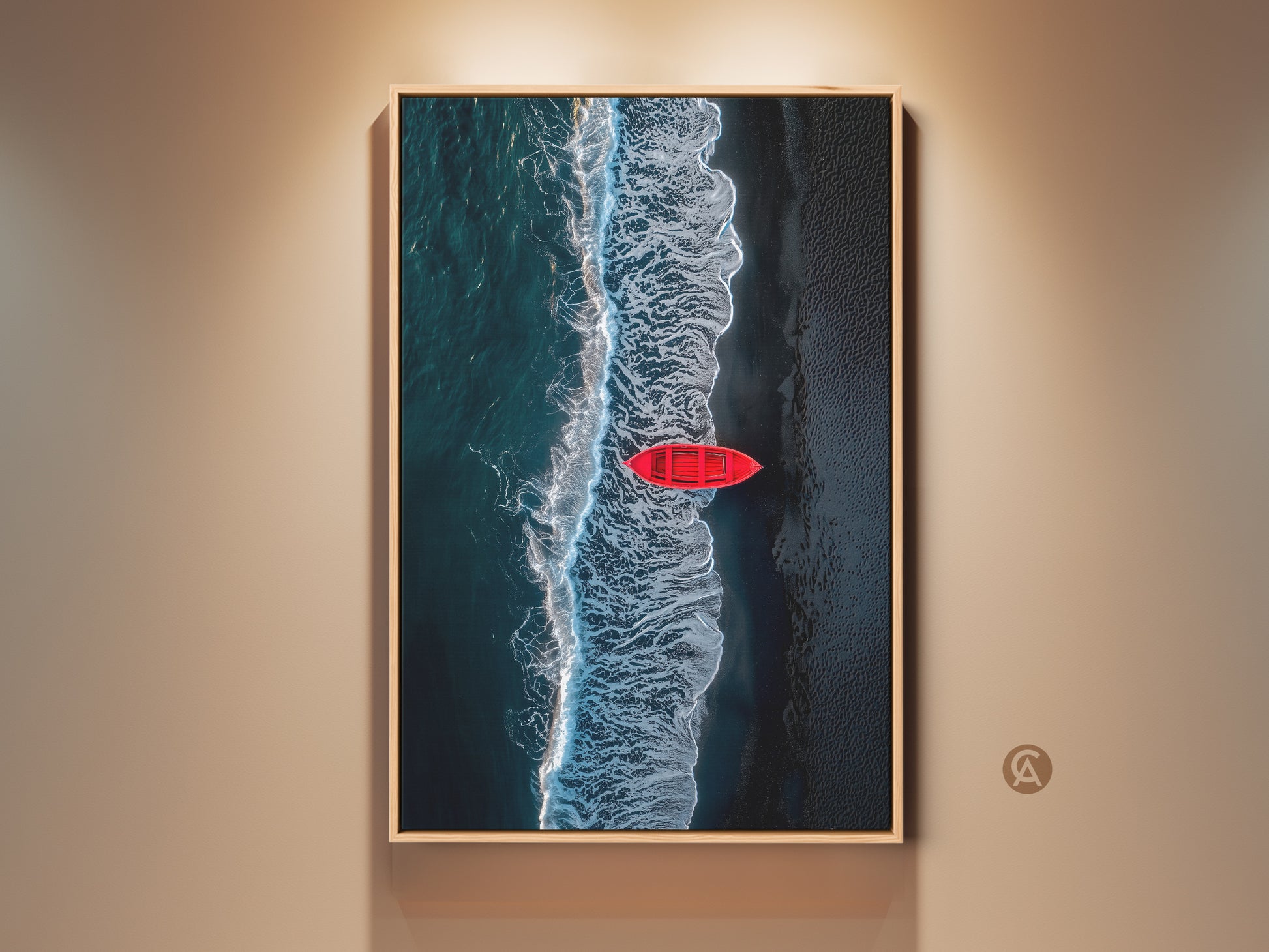 Framed aerial beach art print. A red rowboat sits on the shore. Waves are crashing next to it. The frame is light wood. This ocean artwork adds coastal charm to any room.