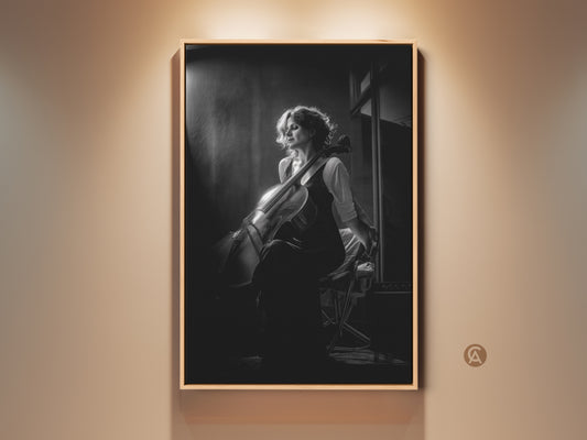 Elegant black and white cello art print. This contemporary portrait features a cellist in a moment of reflection. Perfect wall decor for a music room or home studio. A thoughtful gift for musicians and classical music enthusiasts. The artwork adds a touch of sophistication to any space.