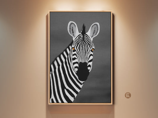 Framed monochrome zebra canvas art in a room setting. The zebra portrait features a minimalist dot art style. This black and white contemporary home decor adds a sophisticated touch. Ideal bedroom wall art for safari theme and modern living spaces.