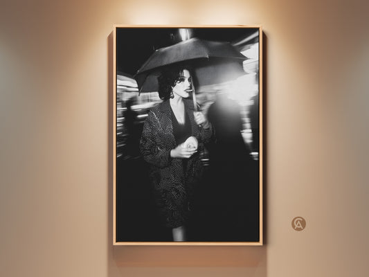 Woman Umbrella Canvas Print for wall art. This street photography captures a monochrome woman in motion. She holds an umbrella. This is a stunning piece of contemporary fashion wall decor for urban spaces. The black and white portrait adds a cinematic touch. It is perfect for chic apartment art.