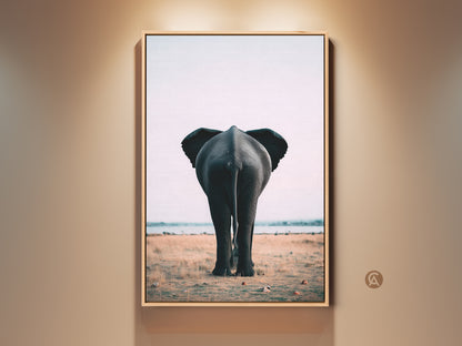 Framed wildlife canvas art featuring an elephant butt print. This contemporary safari decor showcases photorealistic animal wall art. Perfect as a unique home accent piece. The frame enhances the minimalist savanna artwork. Add wild charm to your living space with this elephant rear view art.