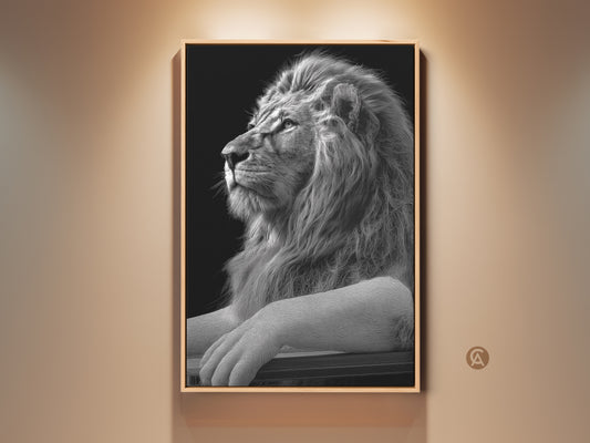 Framed monochrome lion art print displayed in a well lit room. This black and white wildlife wall art adds regal elegance to any space. A perfect gift for lion lovers looking for study or office decor.