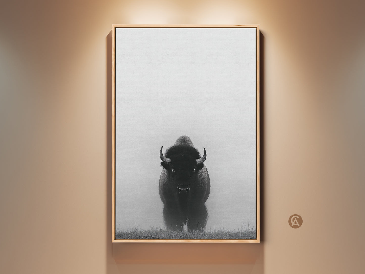 A framed monochrome bison art print hangs on a tan wall. This rustic landscape canvas adds a touch of nature to any entryway. The minimalist black and white wildlife decor is a farmhouse gift.