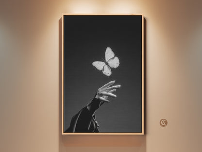 Minimalist black and white butterfly art print. This canvas features an insect interacting with a human hand. Contemporary artwork is perfect for bedroom or living room decor. A thoughtful gift for nature lovers. Add elegance to any space
