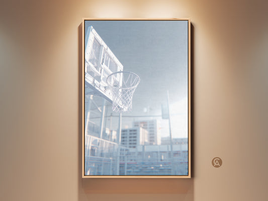 Framed basketball hoop art print. The low angle shot captures the net. Sunlight shines through the clear backboard. Find art prints for sports fans. This artwork is ready to hang.