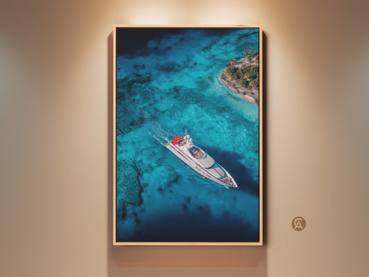 Framed aerial artwork showcasing a yacht sailing on turquoise waters near a tropical island. The art is displayed in a warm-toned frame creating a luxurious nautical theme. This eye-catching wall art brings a serene coastal vibe to any space. Perfect for yachting enthusiasts and lovers of ocean scenery.