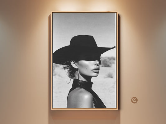 Framed glamour monochrome portrait art print. A woman with a hat showcased as chic wall decor. The black and white tones bring sophisticated style to this fine art piece. This artwork is perfect for a contemporary home or office setting adding an elegant touch to any room.