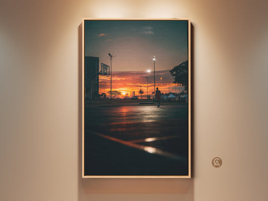 Framed sunset basketball court art print. The warm hues of the sunset create a serene yet energetic vibe. This artwork is perfect for sports enthusiasts and sunset lovers alike.