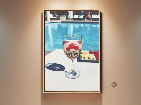 Contemporary canvas art features a glass of raspberry rosé poolside. Aqua and pink hues create a refreshing summer vibe. Perfect wine lover gift adds chic style to dining or bar decor. This modern lifestyle wall art captures leisure and elegance.