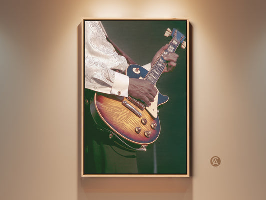 Vintage guitarist canvas print in a floating frame. The art features a retro amber and dark green electric guitar. This eclectic home decor gift is perfect for musicians. It enhances any music room or office with its artistic vibe.