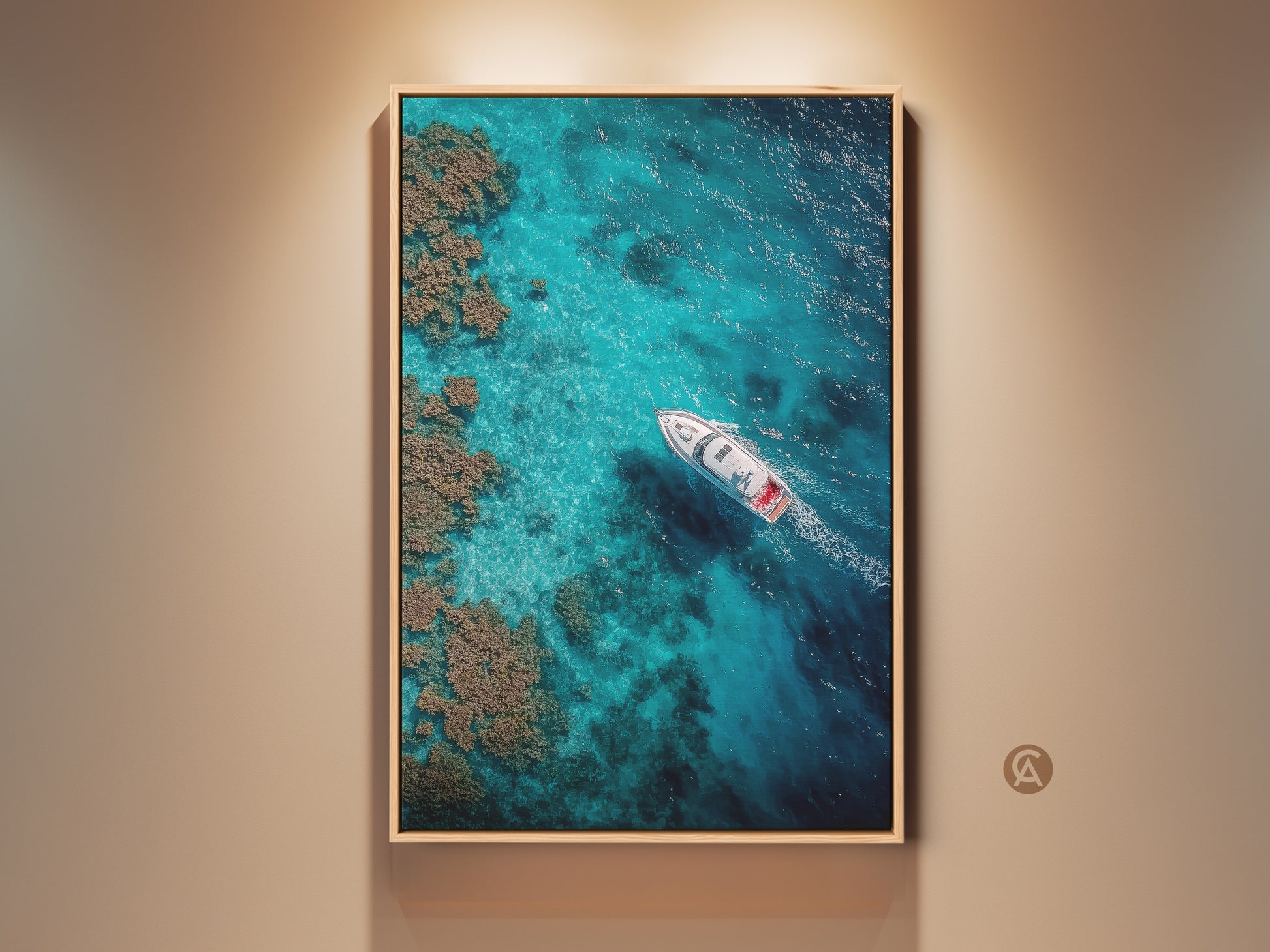 Framed aerial fine art photograph. The artwork shows a boat sailing on clear turquoise waters. Coral reefs are visible near the boat. This ocean art is perfect for coastal home decor.