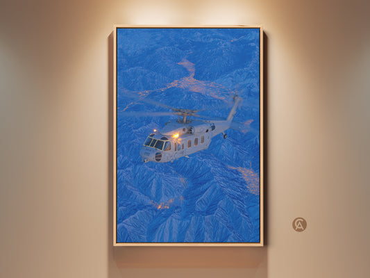 Helicopter soars over a blue mountain range in this captivating artwork. The canvas art is framed in a natural wood finish. It adds a touch of modern aviation to any room. This framed canvas is ready to hang and enjoy.