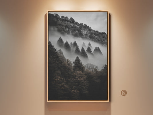 Framed dark green forest canvas print. This monochrome mountain wall art features pine trees in a foggy landscape. Perfect bedroom wall decor for modern nature art lovers. This atmospheric forest canvas brings woodland beauty to any home. A great housewarming gift art.
