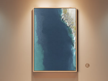 Framed Coastal Abstract Wall Art. This aerial ocean canvas print features deep blue and aqua hues. A minimalist shoreline artwork perfect as bedroom decor or a thoughtful housewarming gift. Contemporary style enhances any space.