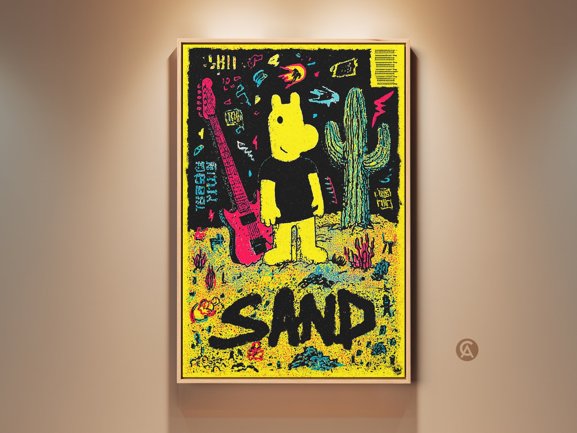 Framed art print featuring a yellow cartoon figure guitar and cactus against a black background. The artwork spells out the word SAND in large black letters. The print is displayed in a light wood frame.