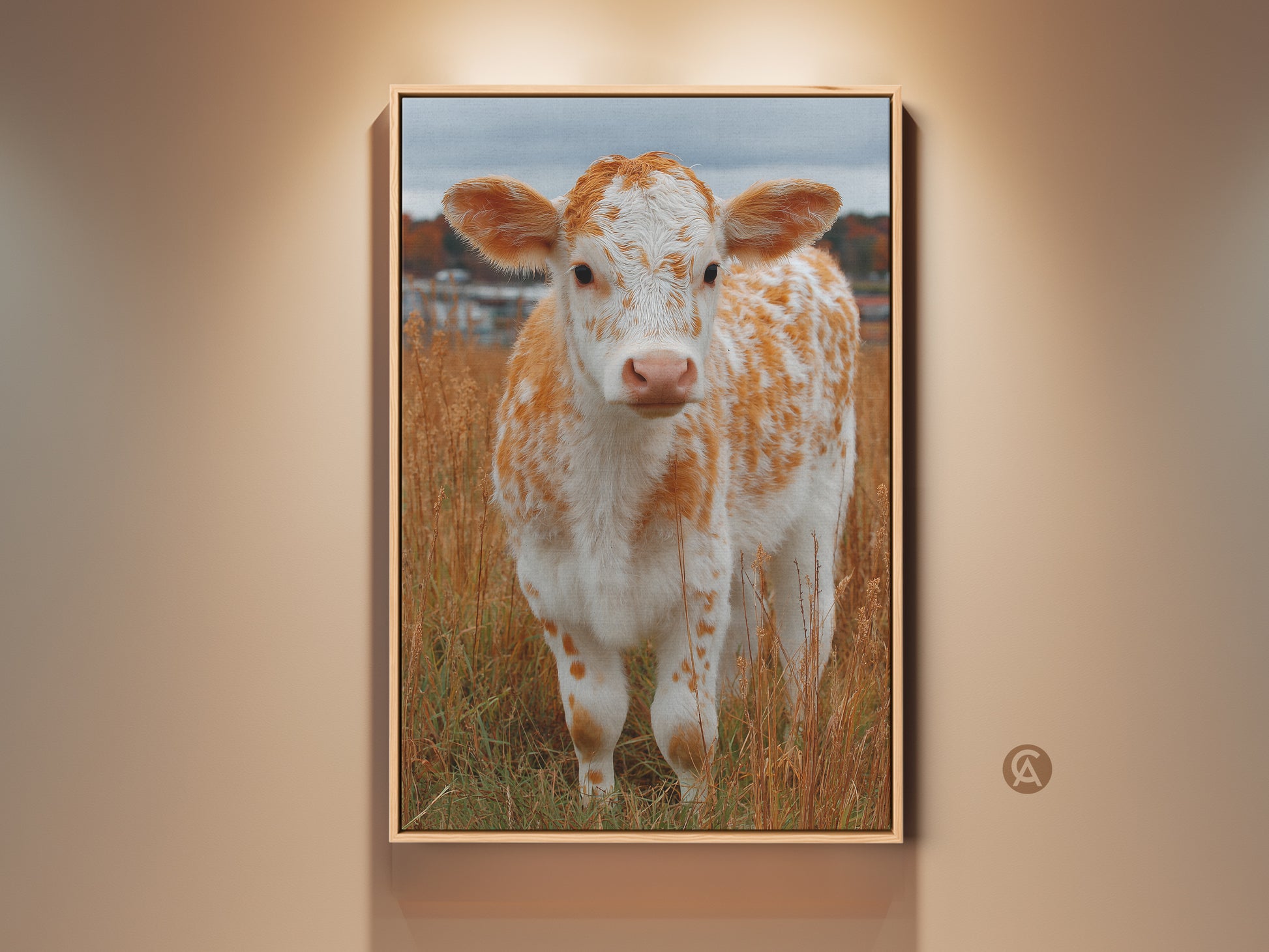 Framed artwork of a cute calf standing in a field of tall grass. This animal art print is perfect for a nursery or child's room. The artwork has a thin gold frame. The calf is white with orange spots. Buy framed canvas art online today.